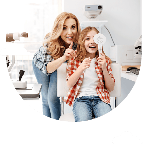 a woman and girl smile during an eye exam