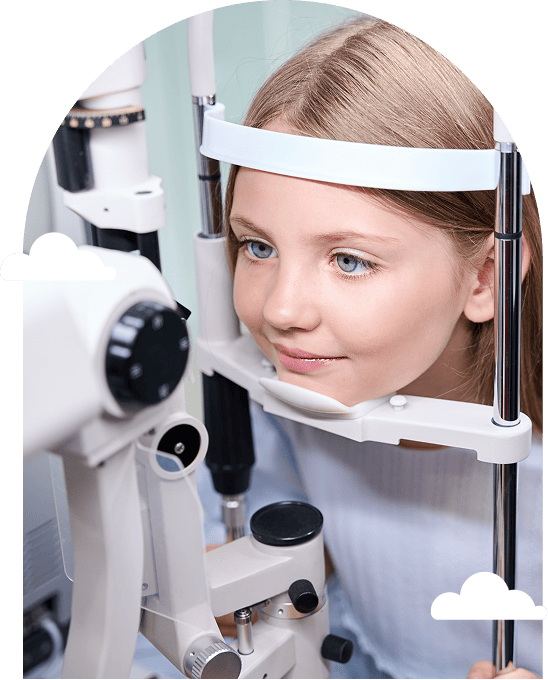 a young girl sits at an eye exam machine